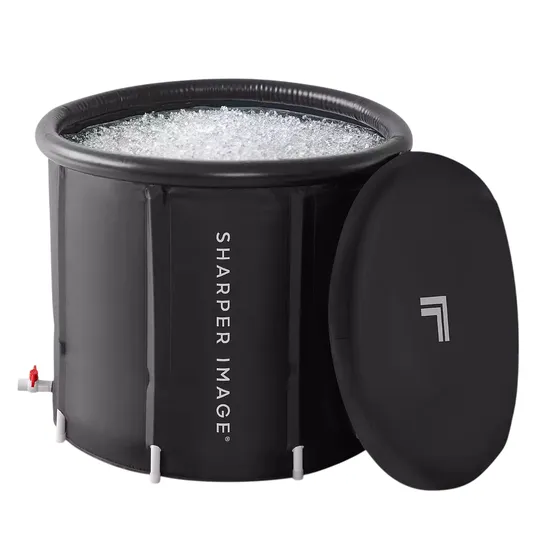 A cylindrical black ice bath with the \“Sharper Image\“ logo, filled with ice, includes a removable lid.