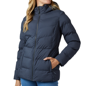 A woman is wearing a dark blue, hooded puffer jacket with a front zipper and side pockets.