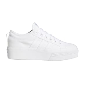 White canvas sneaker with a thick sole, featuring a lace-up design and subtle side stripe detailing.