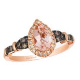 A rose gold ring featuring a pear-shaped morganite center stone, surrounded by a halo of white diamonds, and accented with chocolate diamonds on the band.
