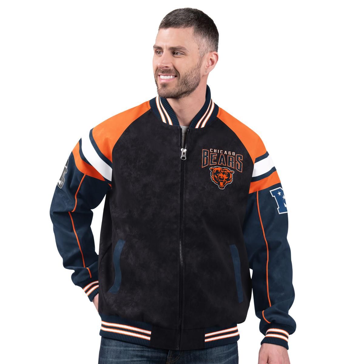 A man is wearing a Chicago Bears themed faux suede jacket with the team's colors and logo, featuring striped cuffs and a zippered front.