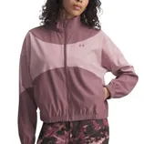A two-tone pink jacket with a full zip, elastic cuffs, and a stand-up collar featuring the Under Armour logo, paired with patterned leggings.