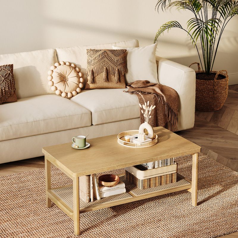 A beige sofa with decorative pillows, a wooden coffee table, woven baskets, and a potted plant.