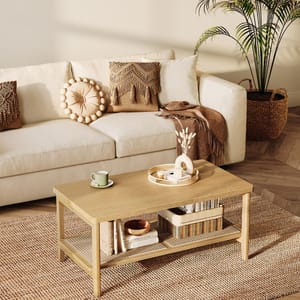 A beige sofa with decorative pillows, a wooden coffee table, woven baskets, and a potted plant.