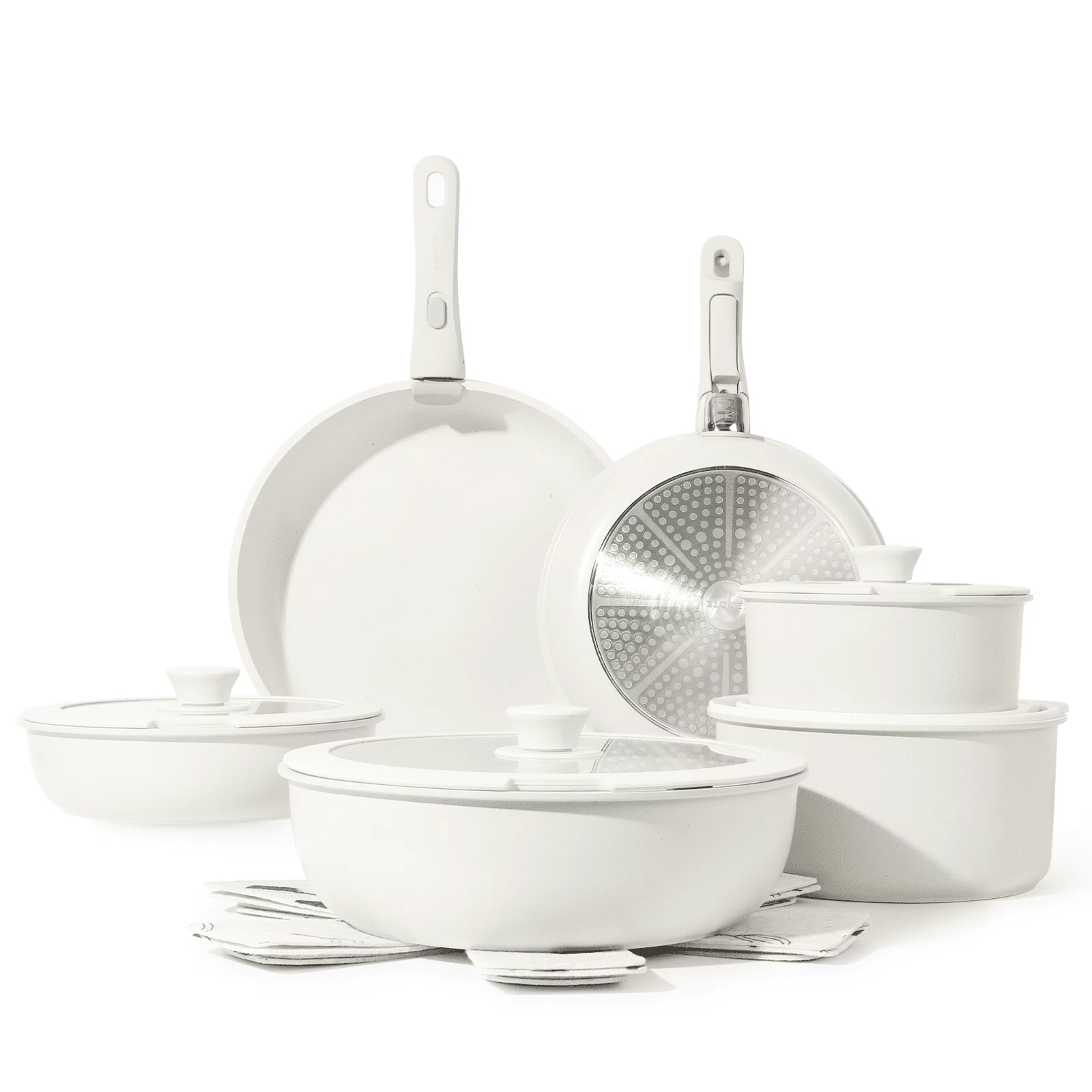 White cookware and bakeware set including frying pans, pots with lids, and baking dishes.