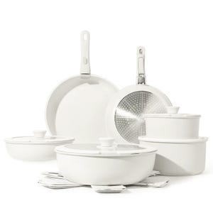 White cookware and bakeware set including frying pans, pots with lids, and baking dishes.