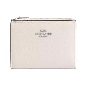 A small, light-colored Coach wallet with a zippered compartment and the brand logo on the front.