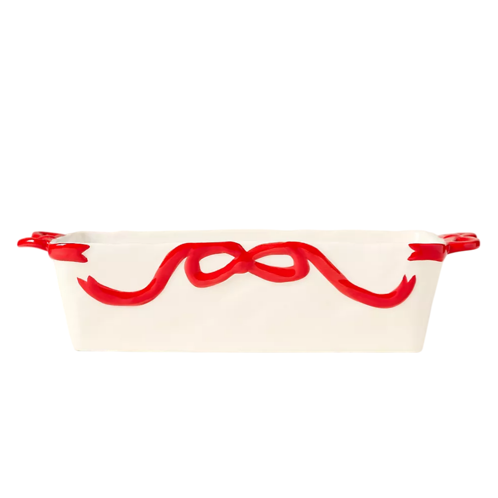 White ceramic baking dish with red ribbon design, featuring two handles.
