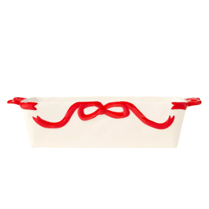 White ceramic baking dish with red ribbon design, featuring two handles.