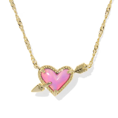 Gold necklace with a chain featuring a heart-shaped pink pendant pierced by an arrow.