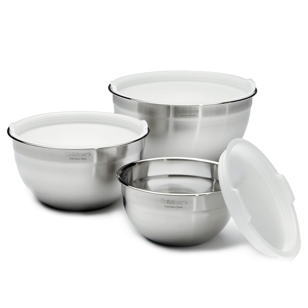 Set of three stainless steel mixing bowls with tight-fitting white lids. Ideal for mixing, storing, and serving. Sizes vary, providing versatility for different kitchen tasks.