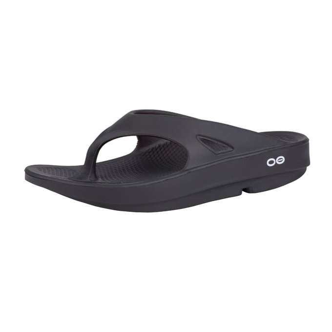 A black ergonomic thong sandal with a thick sole and textured footbed, featuring a minimalist design with a small white logo on the side.