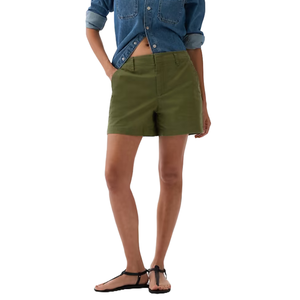 Olive green khaki shorts with a mid-rise waist, two side pockets, and a relaxed fit. Paired with a denim shirt and black sandals.