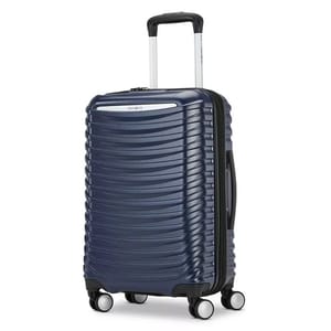 A blue hard-shell suitcase with a ribbed design, featuring four dual spinner wheels and a telescopic handle.