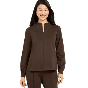 A woman is wearing a brown long-sleeve top with a keyhole neck and matching pants.
