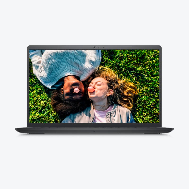 A laptop displaying a high-resolution photo of two people lying on grass, touching noses playfully.