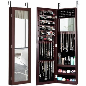 Wall-mounted jewelry organizer with mirror, featuring hooks and shelves for necklaces, earrings, rings, and cosmetics.