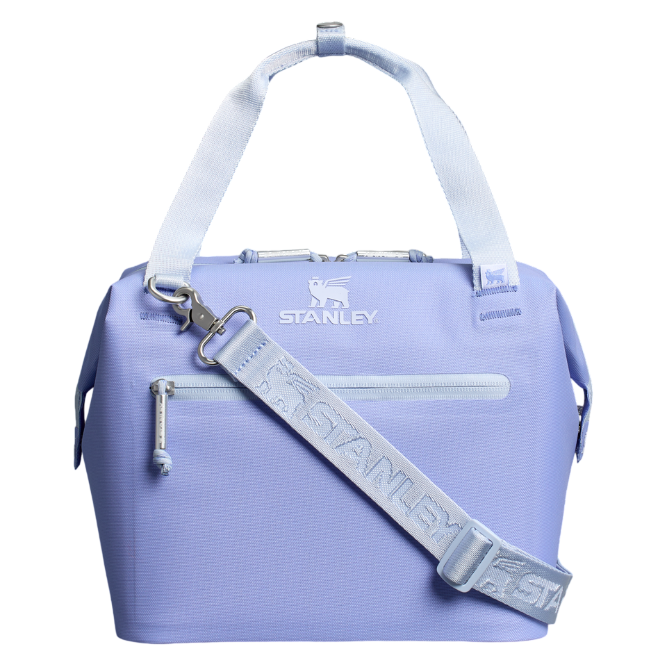 Light purple Stanley cooler bag with dual handles and an adjustable shoulder strap, featuring a front zippered pocket and logo branding.
