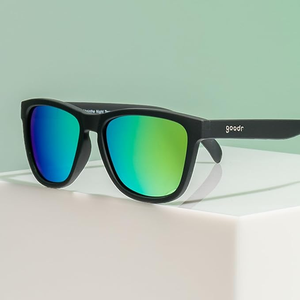 Sunglasses with black frames featuring reflective blue-green lenses and the brand name \“goodr\“ on the temple.
