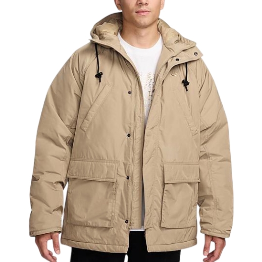 A beige Nike parka jacket with a hood, featuring drawstrings and large front pockets. It's designed for warmth and comfort, with button and zipper closure.