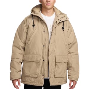 A beige Nike parka jacket with a hood, featuring drawstrings and large front pockets. It's designed for warmth and comfort, with button and zipper closure.