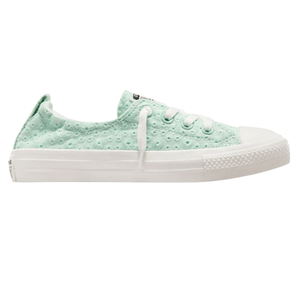 Mint green low-top sneaker with a textured floral pattern, white laces, and a white rubber sole.
