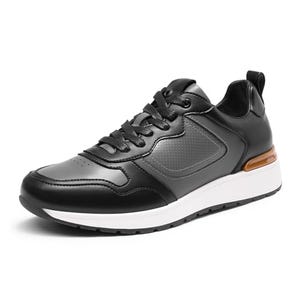 Black leather sneakers with a white sole, featuring a lace-up design and a discreet air-cushioned heel for arch support.