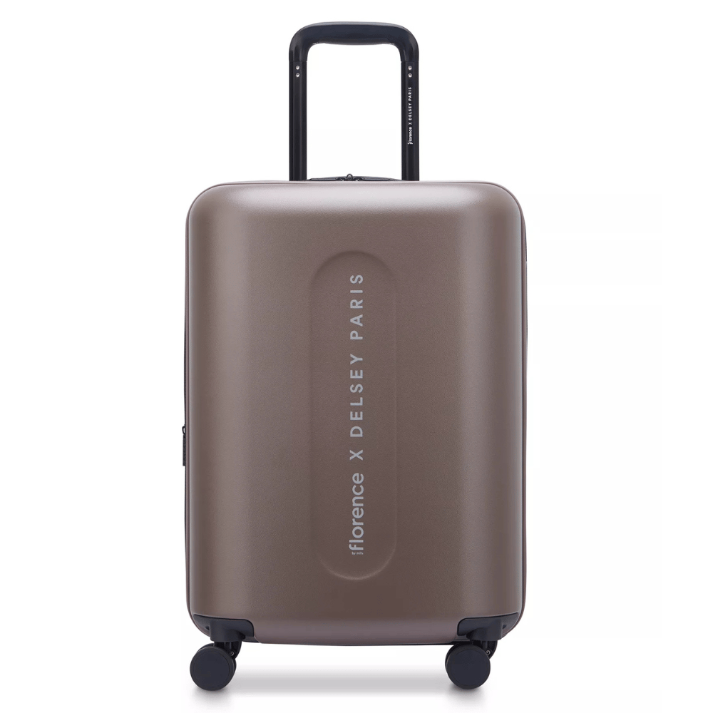 A brown hard-shell suitcase labeled \“florence X DELSEY PARIS,\“ featuring a retractable handle and four spinner wheels for easy mobility.