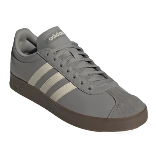 Gray Adidas sneakers featuring three white stripes and a brown sole, with laces and a logo on the tongue.