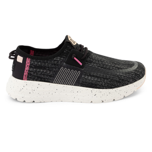 Hey Dude Sirocco Slip-On Shoes feature a black textured upper with pink accents, set on a white speckled sole. They have a casual, sporty design with lace-up details, providing a comfortable fit.
