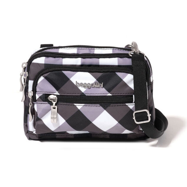 A small crossbody bag with a black-and-white checkered pattern and multiple zip compartments.