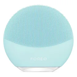 A light blue facial cleansing brush with silicone bristles, labeled \“Foreo,\“ designed for gentle skin care.