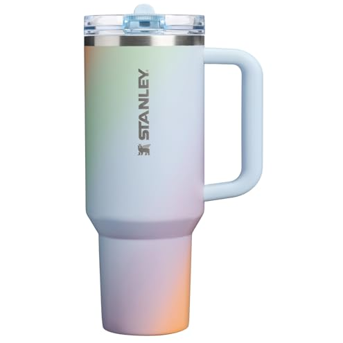 A Stanley insulated tumbler with a handle and a lid, featuring a gradient color design.