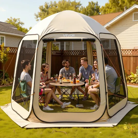 A group of people is seated inside a VEVOR pop-up gazebo tent enjoying drinks and snacks, set up in a backyard.