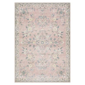 The Langley Street Washable Floral Rug features a traditional floral pattern with a soft, vintage look, primarily in muted pink and green tones. The intricate design is bordered and symmetrical, offering a classic aesthetic.