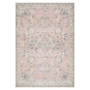 The Langley Street Washable Floral Rug features a traditional floral pattern with a soft, vintage look, primarily in muted pink and green tones. The intricate design is bordered and symmetrical, offering a classic aesthetic.