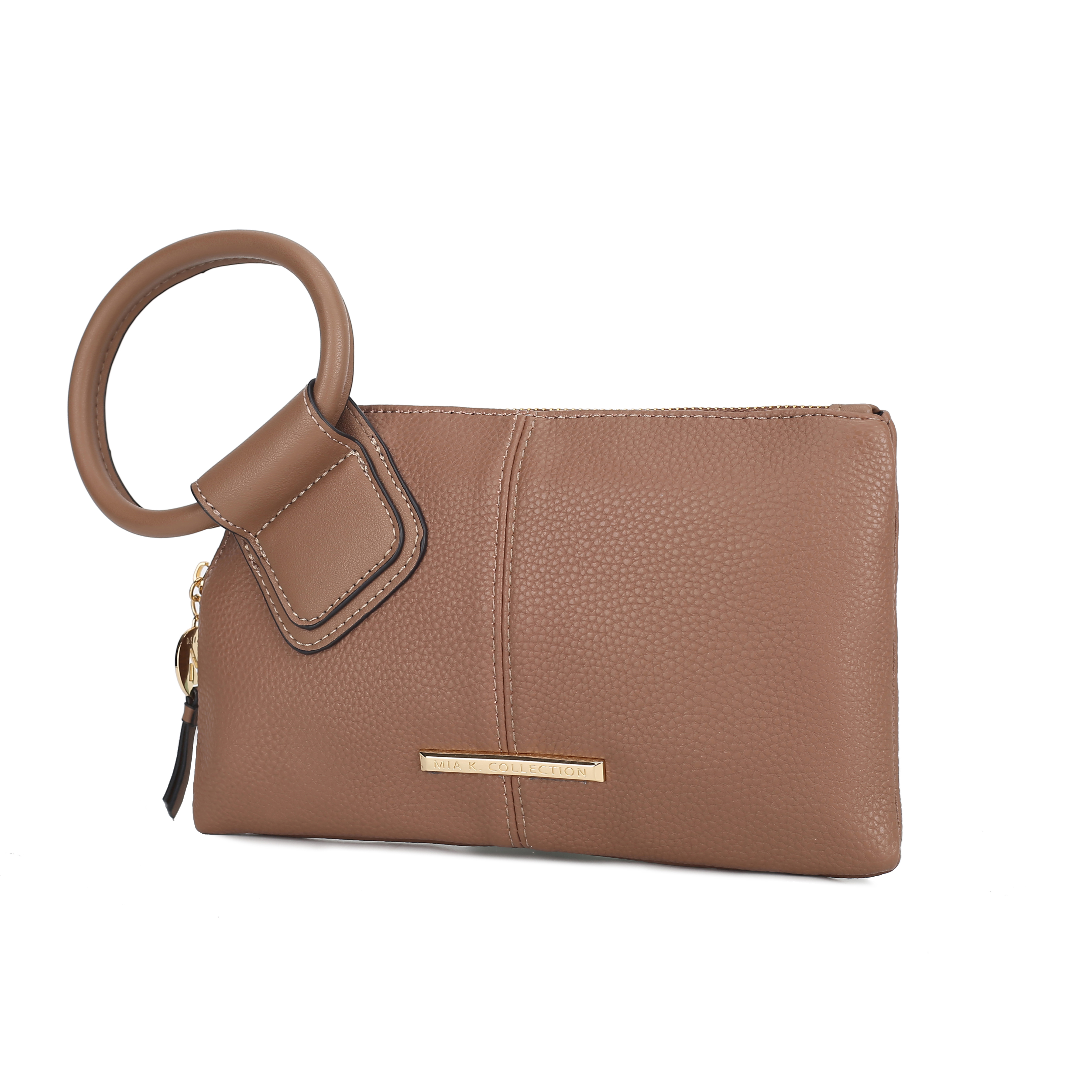 A tan wristlet clutch with a circular handle and gold-tone metal branding plaque.