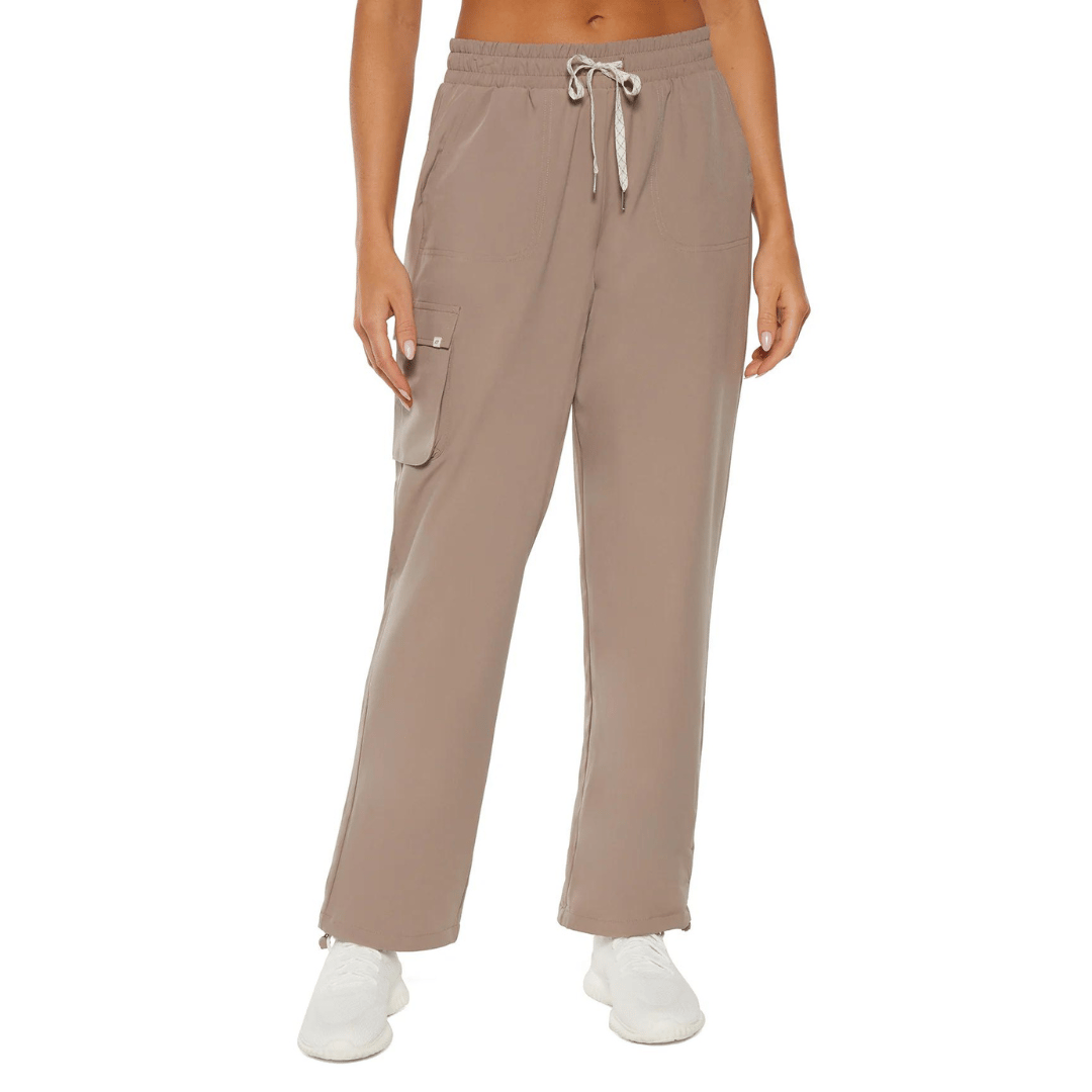 Taupe cargo-style joggers with a drawstring waist and side pockets, paired with white sneakers.