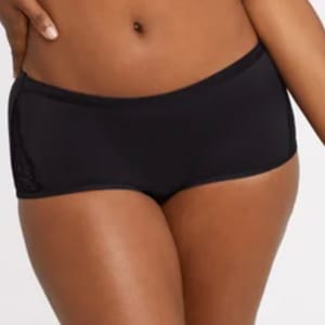 A person wearing black swim shorts.