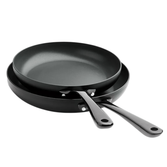 Two black non-stick frying pans with matching handles, stacked together.