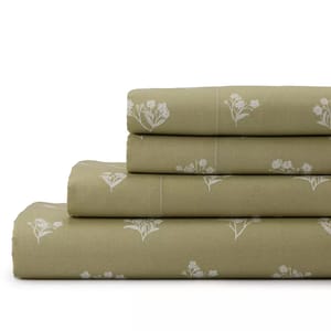 A stack of olive green bed sheets featuring a white floral pattern.