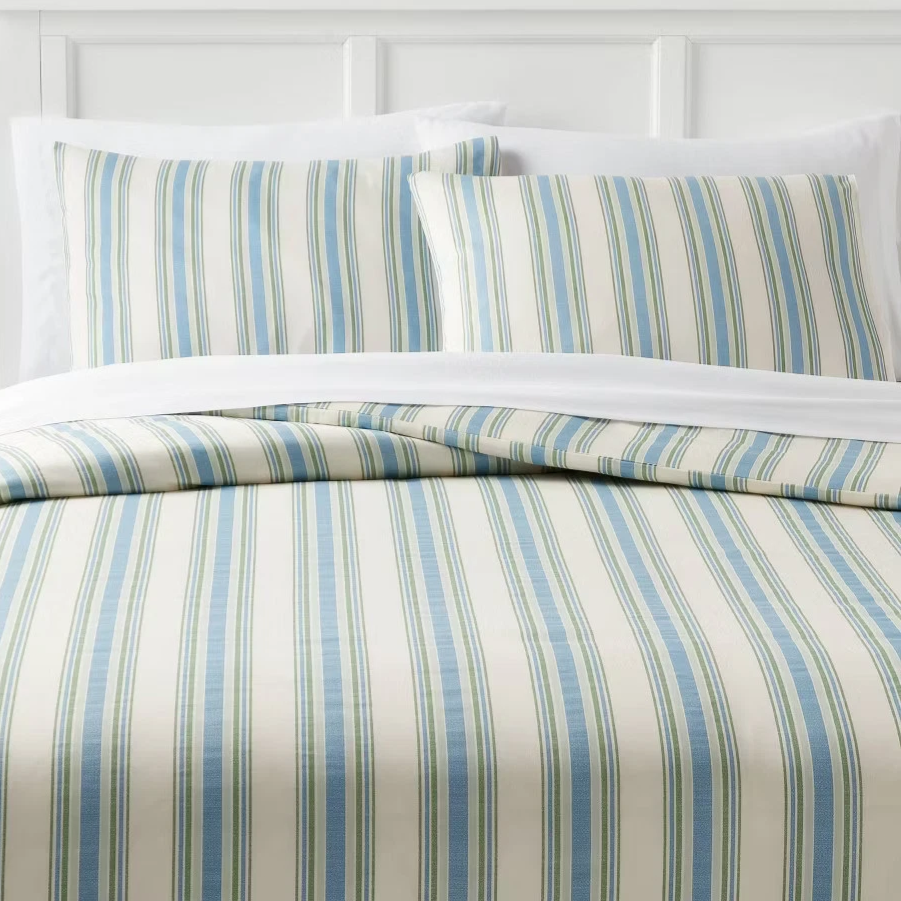 Striped bedding set featuring a pattern of blue and green vertical lines on a cream background, including a duvet and two pillowcases.