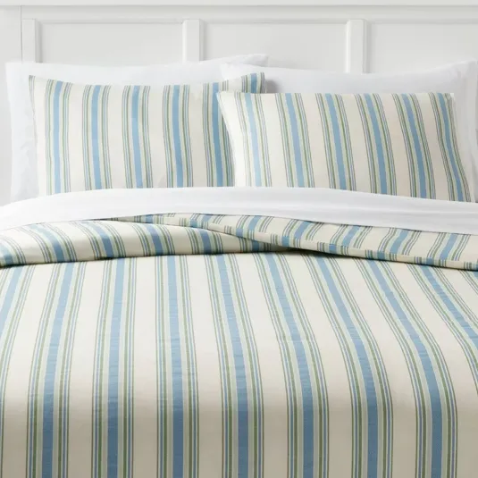 Striped bedding set featuring a pattern of blue and green vertical lines on a cream background, including a duvet and two pillowcases.