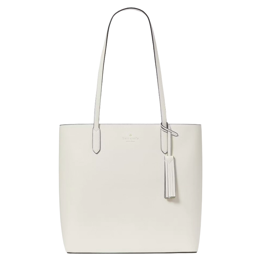 A white leather tote bag with long handles, featuring a tassel accent and subtle branding near the top.