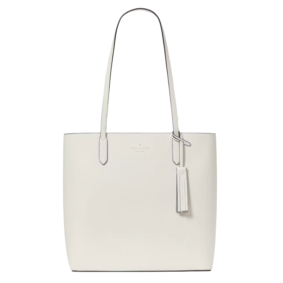 A white leather tote bag with long handles, featuring a tassel accent and subtle branding near the top.
