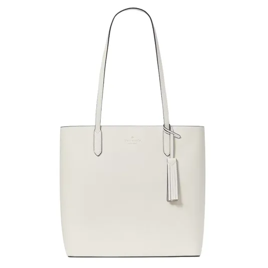 A white leather tote bag with long handles, featuring a tassel accent and subtle branding near the top.