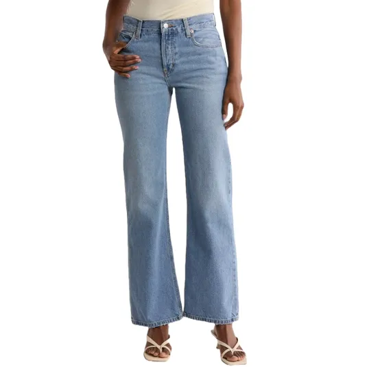 Light blue high-waisted, flared jeans paired with strappy sandals.