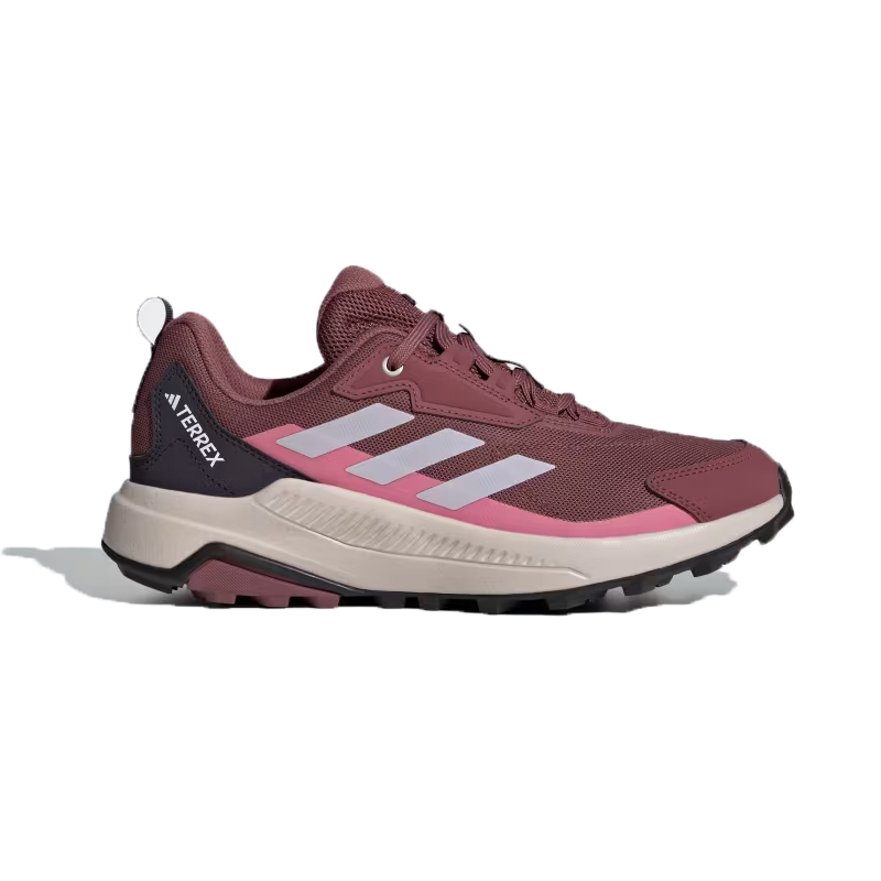 The Adidas Terrex Anylander Shoes are maroon hiking sneakers featuring a robust sole with pink and white stripe details, a black heel accent, and the “Terrex” logo. They are designed for durability and style in outdoor activities.