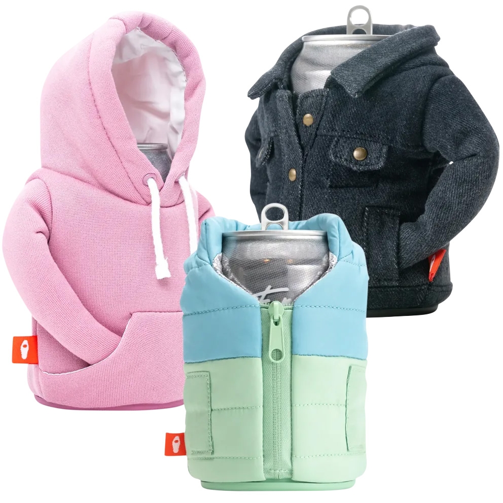 A set of three insulated can coolers designed as mini jackets: one pink hoodie, one black denim jacket, and one color-block puffer jacket in blue and green, each featuring realistic garment details.