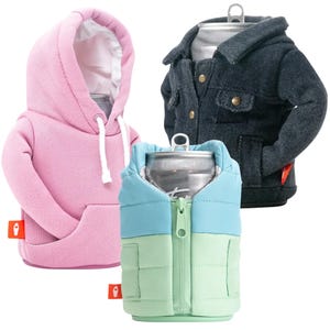 A set of three insulated can coolers designed as mini jackets: one pink hoodie, one black denim jacket, and one color-block puffer jacket in blue and green, each featuring realistic garment details.